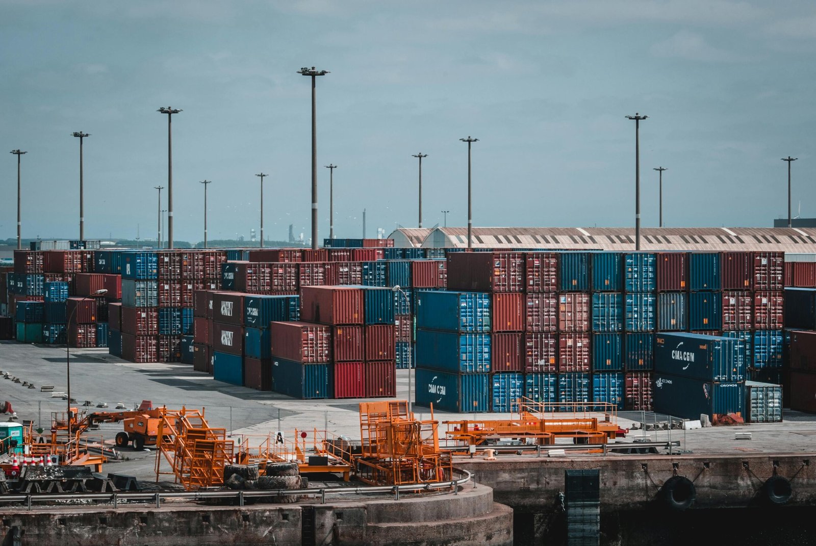 Colorful cargo containers stacked at a busy industrial port, showcasing global trade.